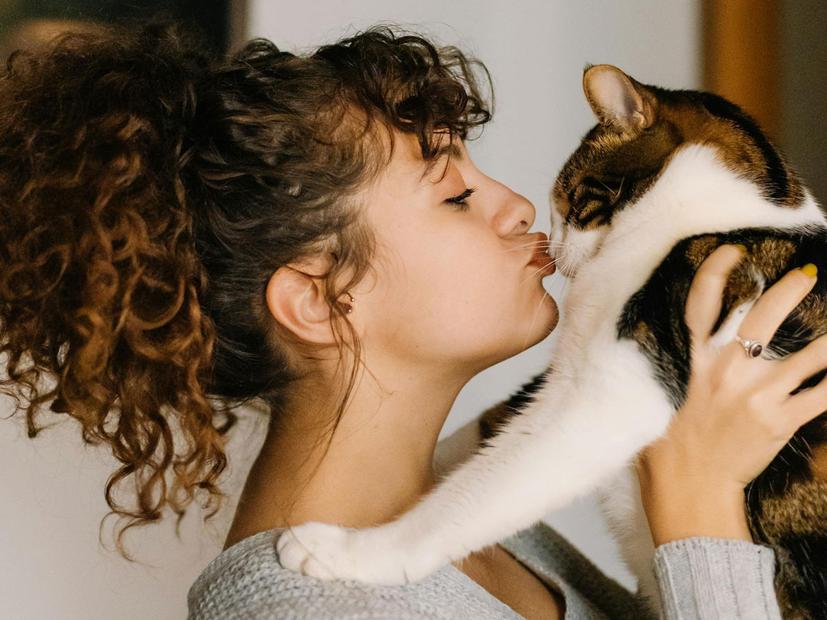 woman kissing her cat