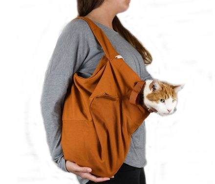 A caramel brown cat pouch carrier