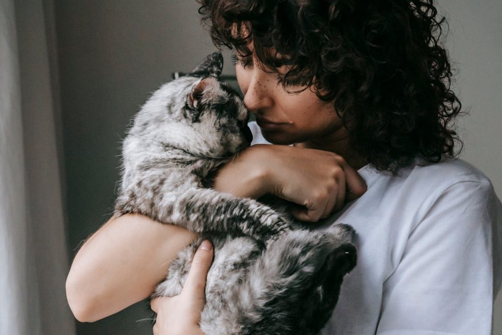 A woman cuddling her pet cat